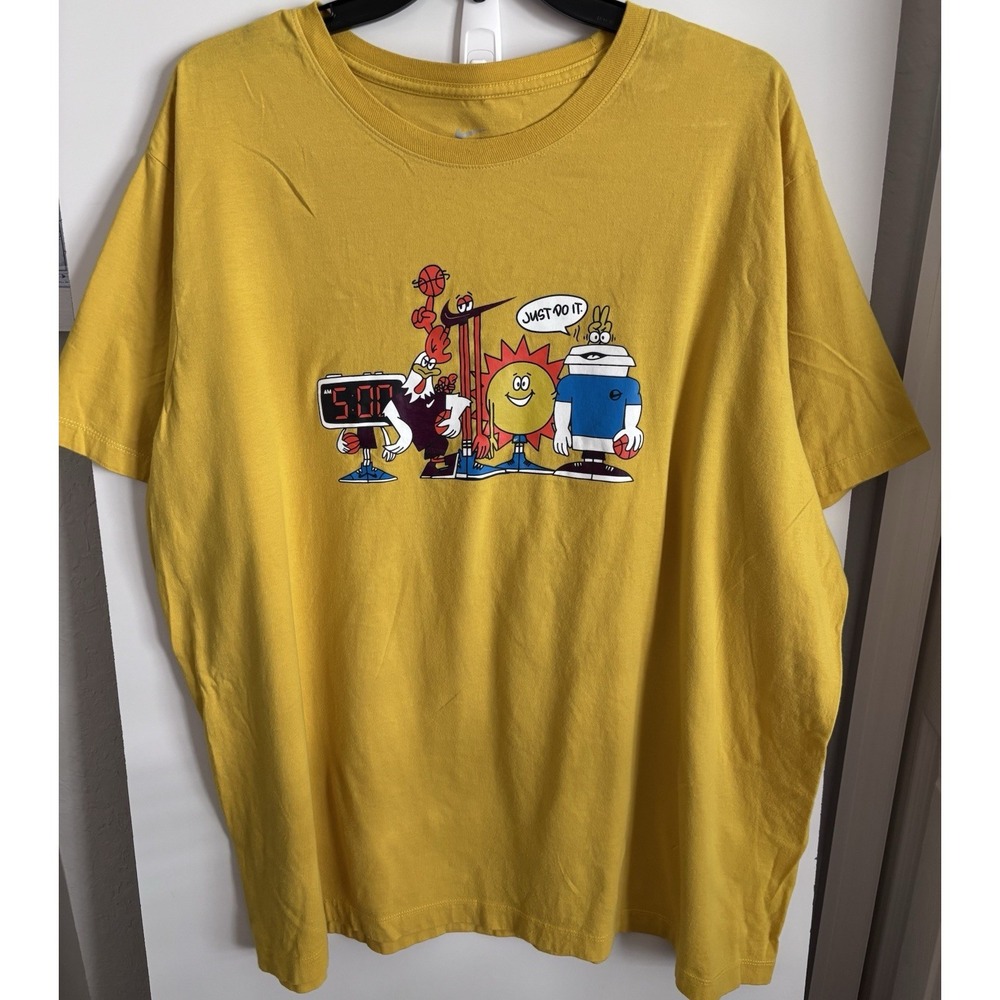 The Nike Cartoon Tee Mustard Yellow Size XXL graphic - Just Do It.